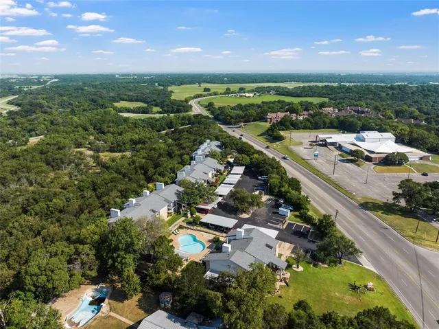 an aerial view of residential houses with outdoor space