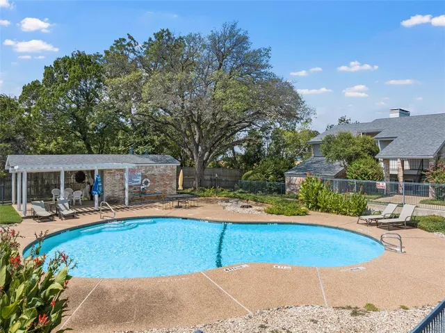 a view of a swimming pool with chairs
