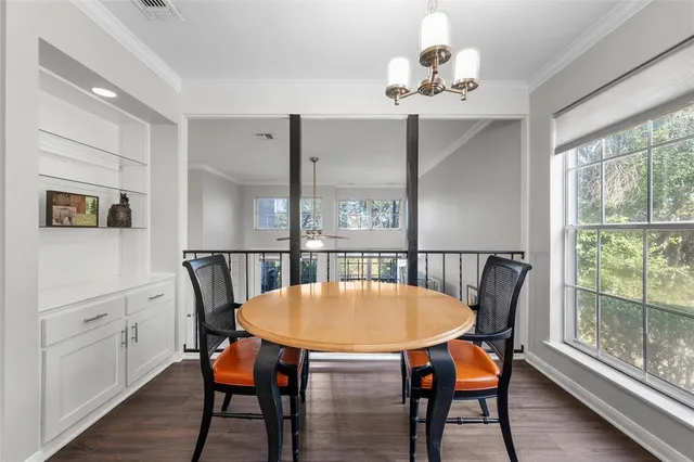a dining room with furniture a chandelier and wooden floor
