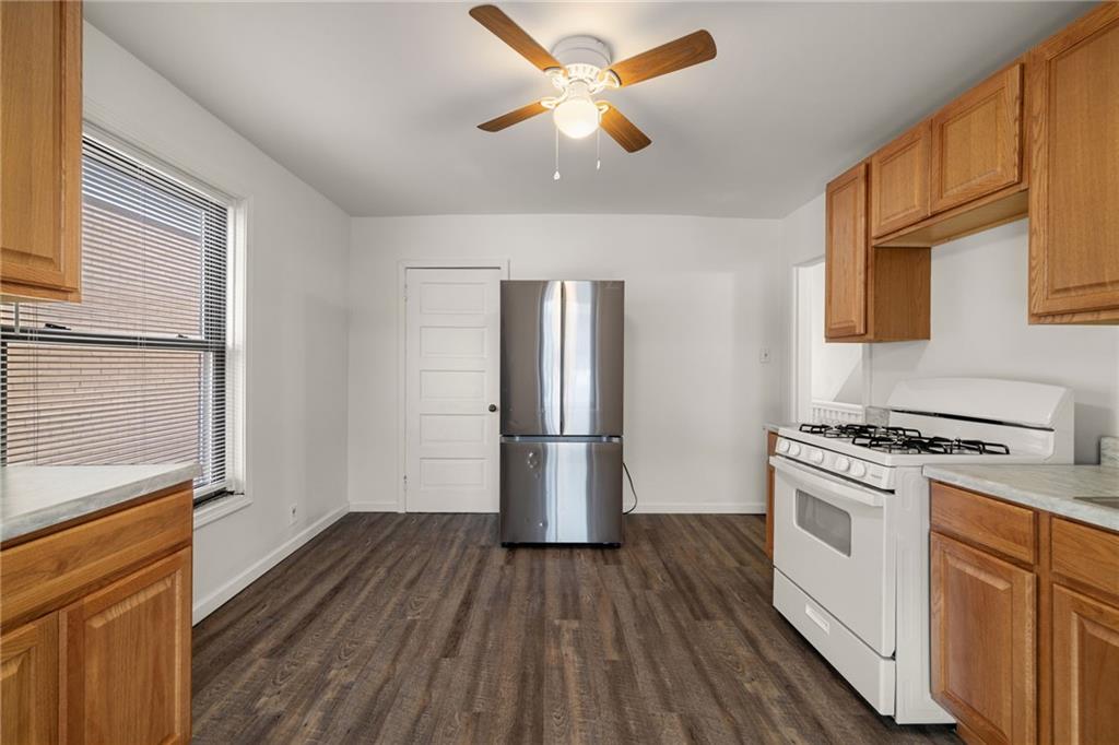 62 Maytide Street Pittsburgh, PA 15227 - Photo 14 of 23 a kitchen with a stove a refrigerator and a microwave
