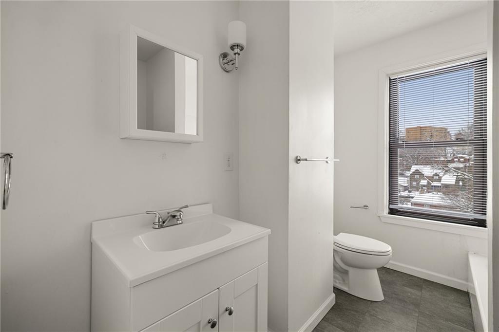 62 Maytide Street Pittsburgh, PA 15227 - Photo 16 of 23 a bathroom with a toilet a sink and a mirror