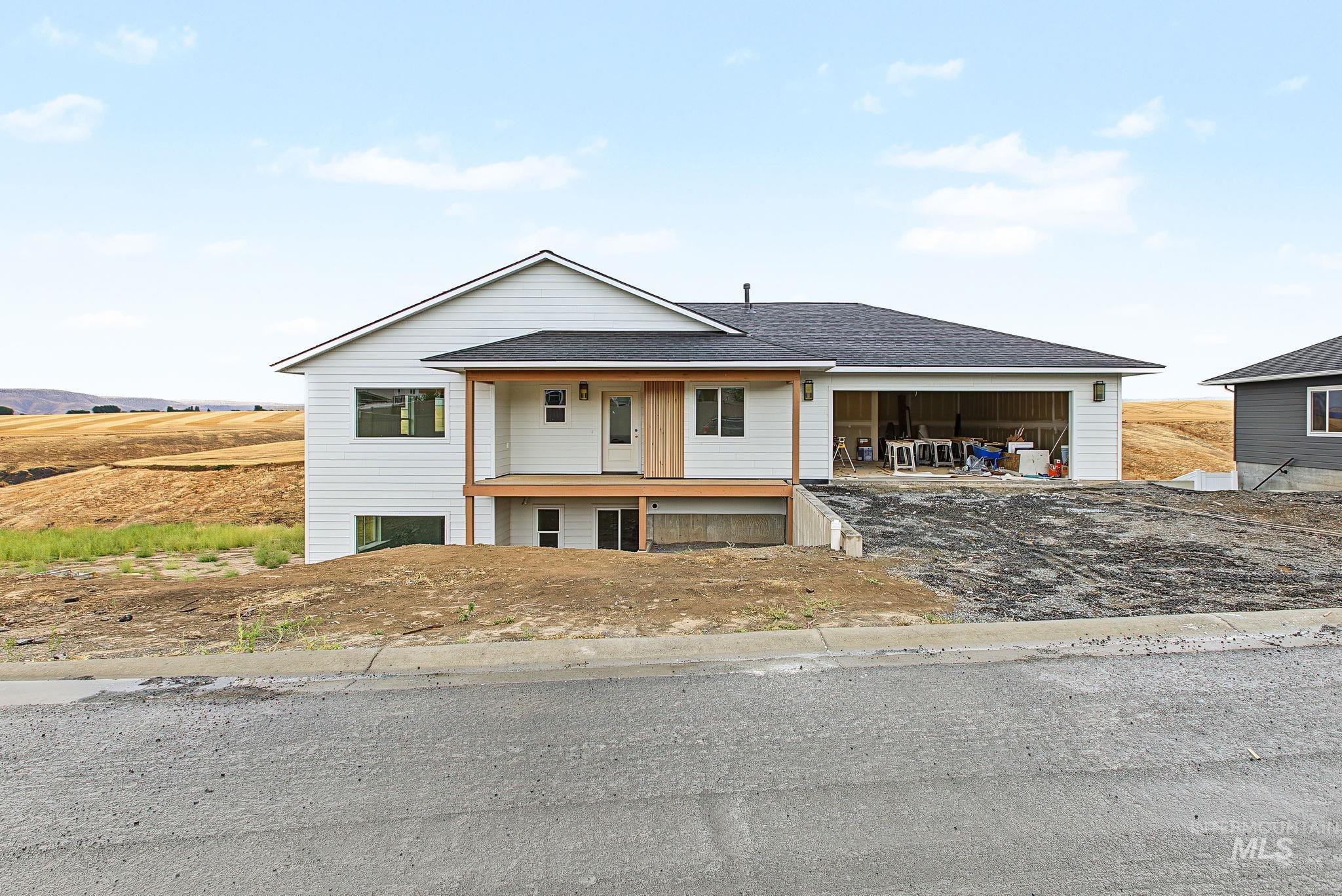 White horizontal siding exterior with a dark shingled roof