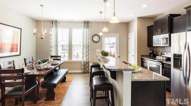 a kitchen with counter space dining table and chairs