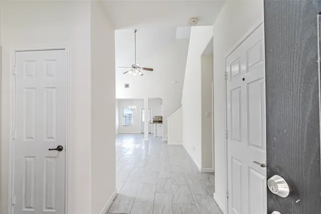a view of empty room with wooden floor