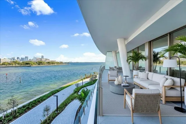 a view of deck with patio and lake view