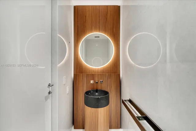 a bathroom with a sink mirror and toilet