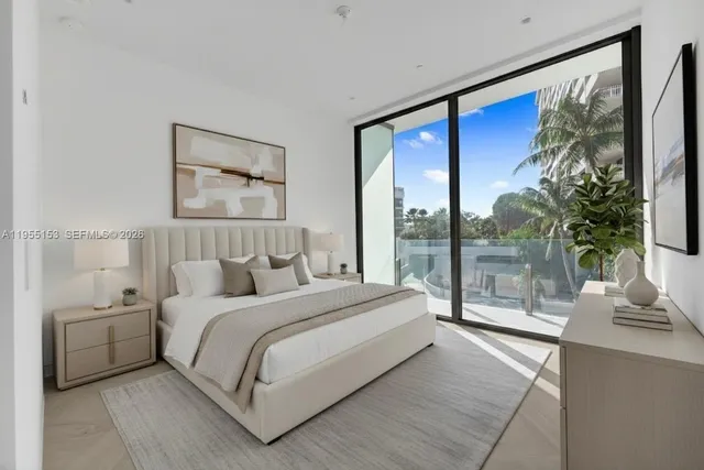 a bedroom with a large bed and a large window with outer view