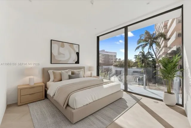 a bedroom with a large bed and a large window