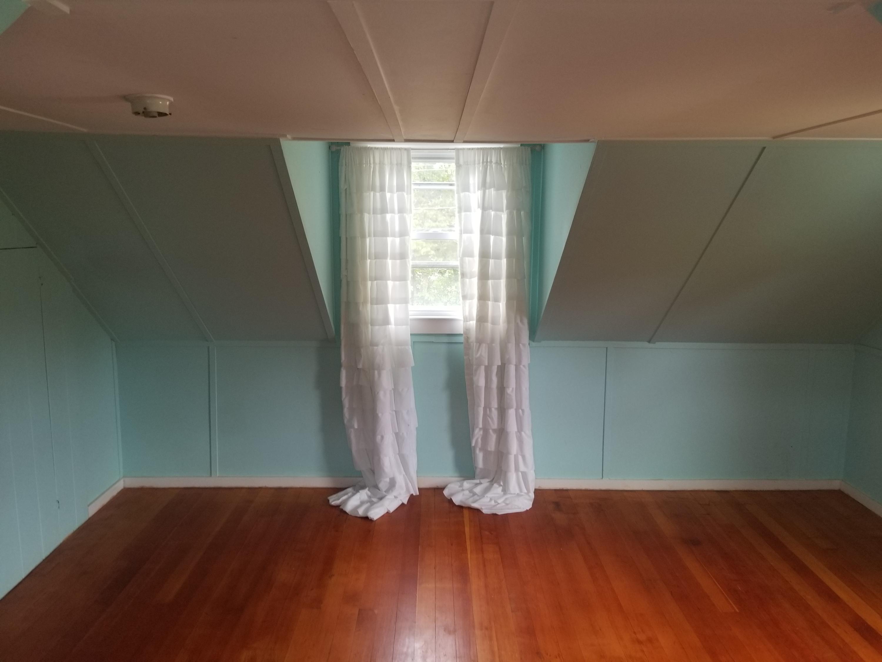 85 Shore Road Bourne, MA 02532 - Photo 12 of 16 an empty room with wooden floor and window