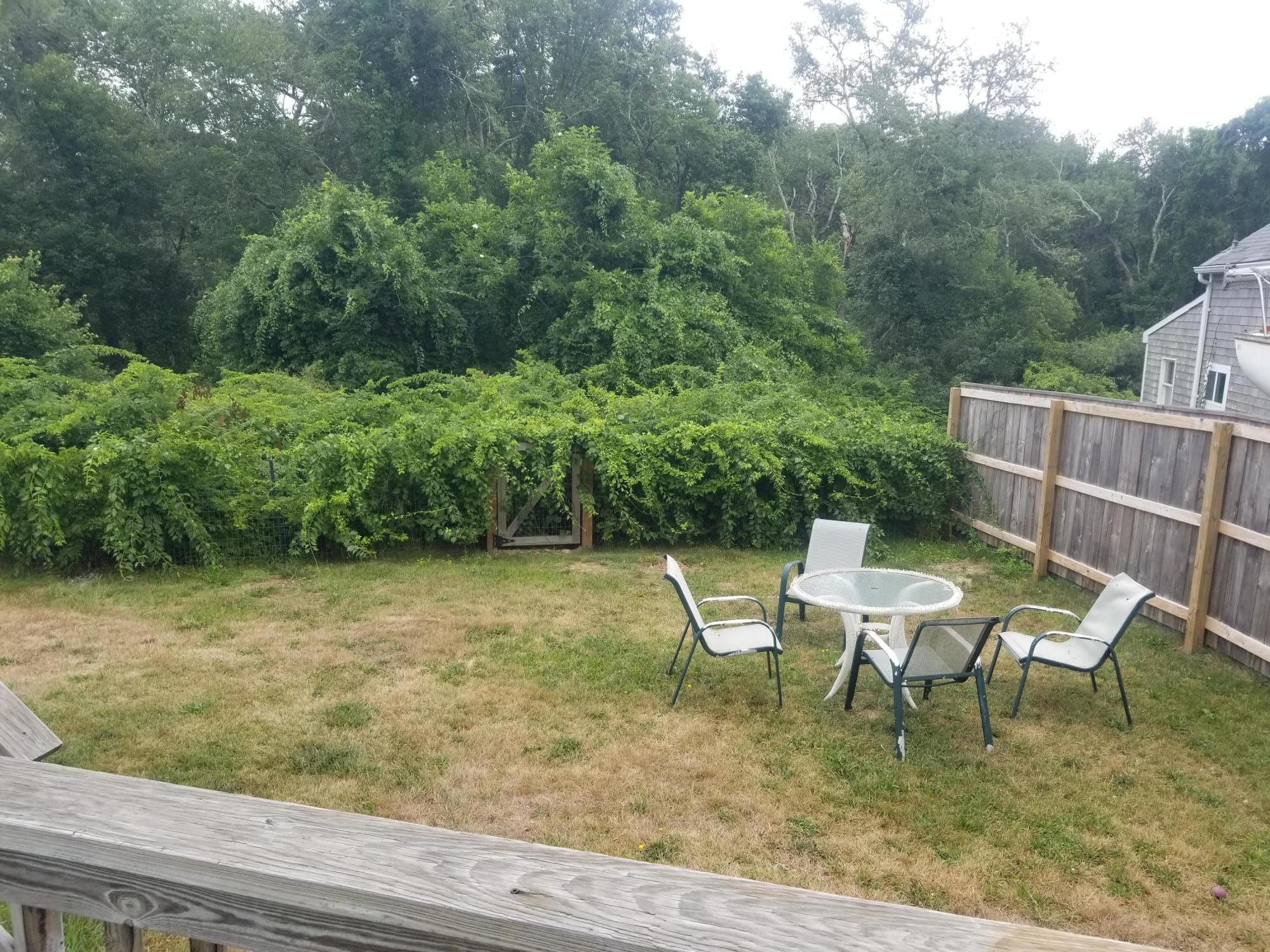 85 Shore Road Bourne, MA 02532 - Photo 14 of 16 a view of a chairs and table in the backyard