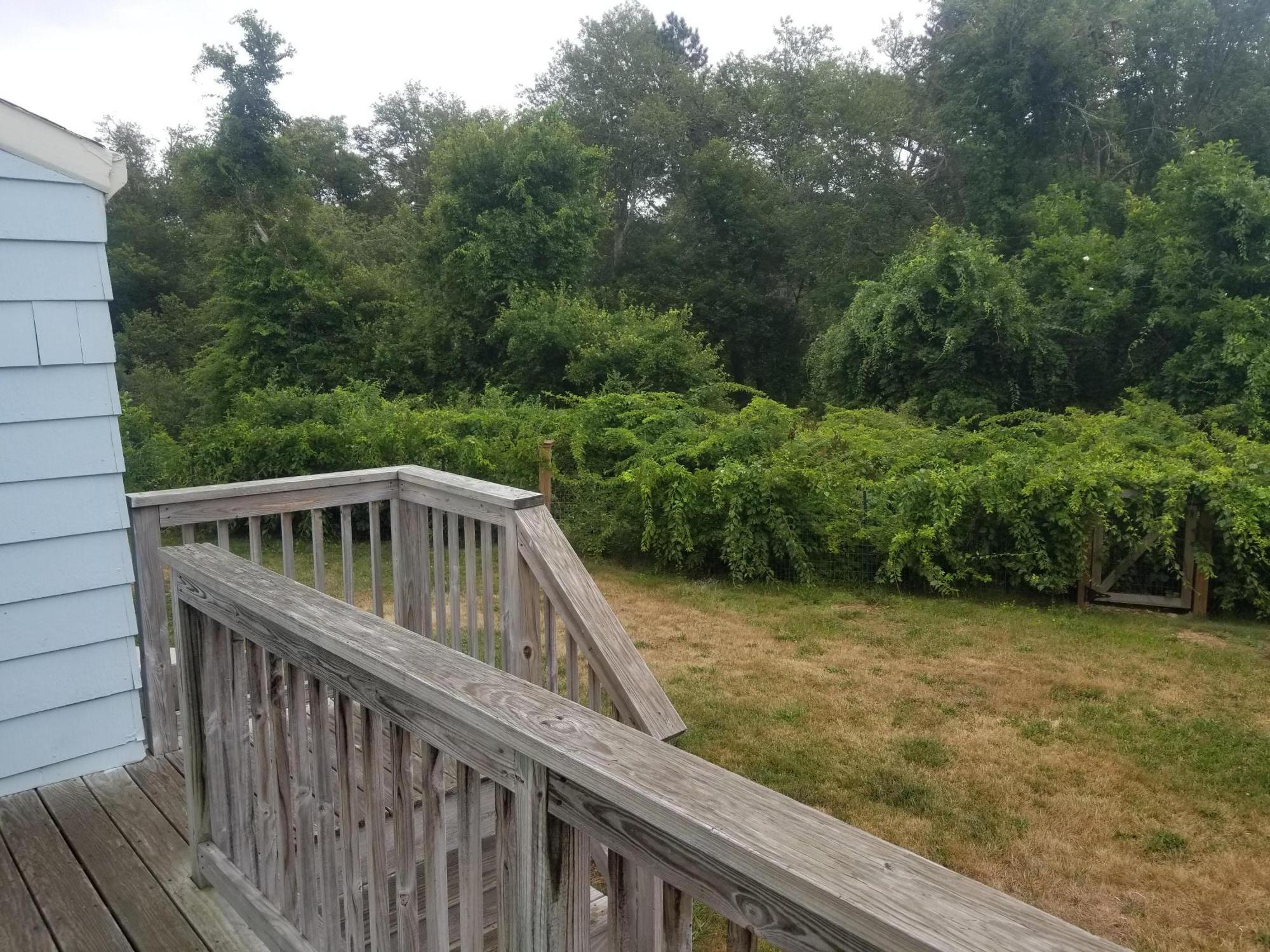 85 Shore Road Bourne, MA 02532 - Photo 15 of 16 a view of backyard with deck and garden