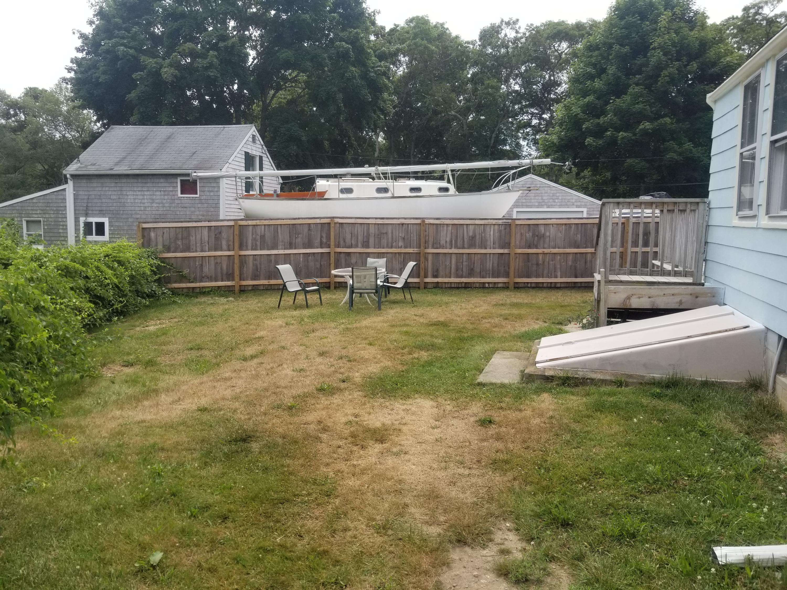 85 Shore Road Bourne, MA 02532 - Photo 16 of 16 a aerial view of a house with swimming pool next to a yard