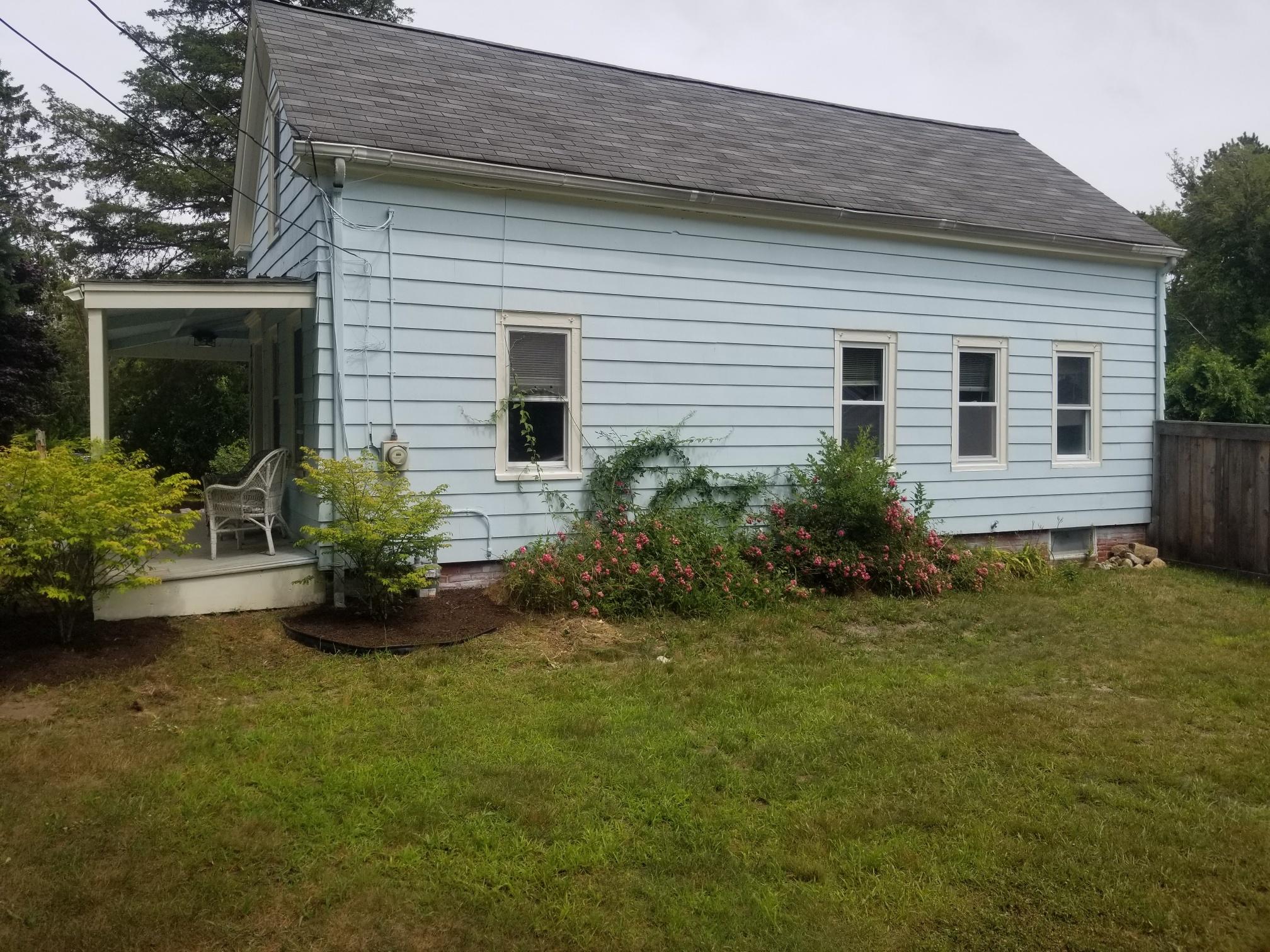 85 Shore Road Bourne, MA 02532 - Photo 2 of 16 a front view of house with yard and green space