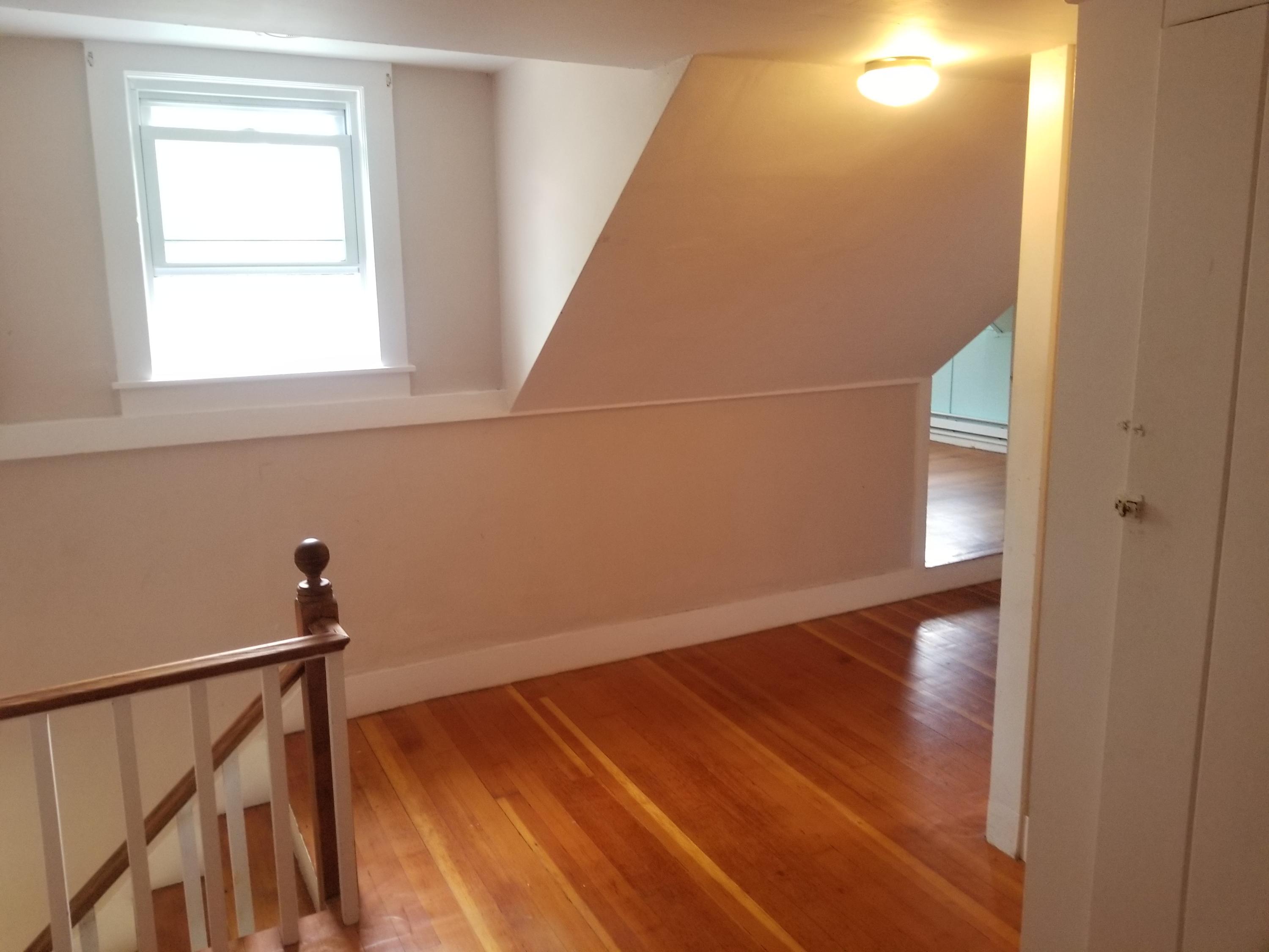 85 Shore Road Bourne, MA 02532 - Photo 8 of 16 a view of empty room with wooden floor and fan