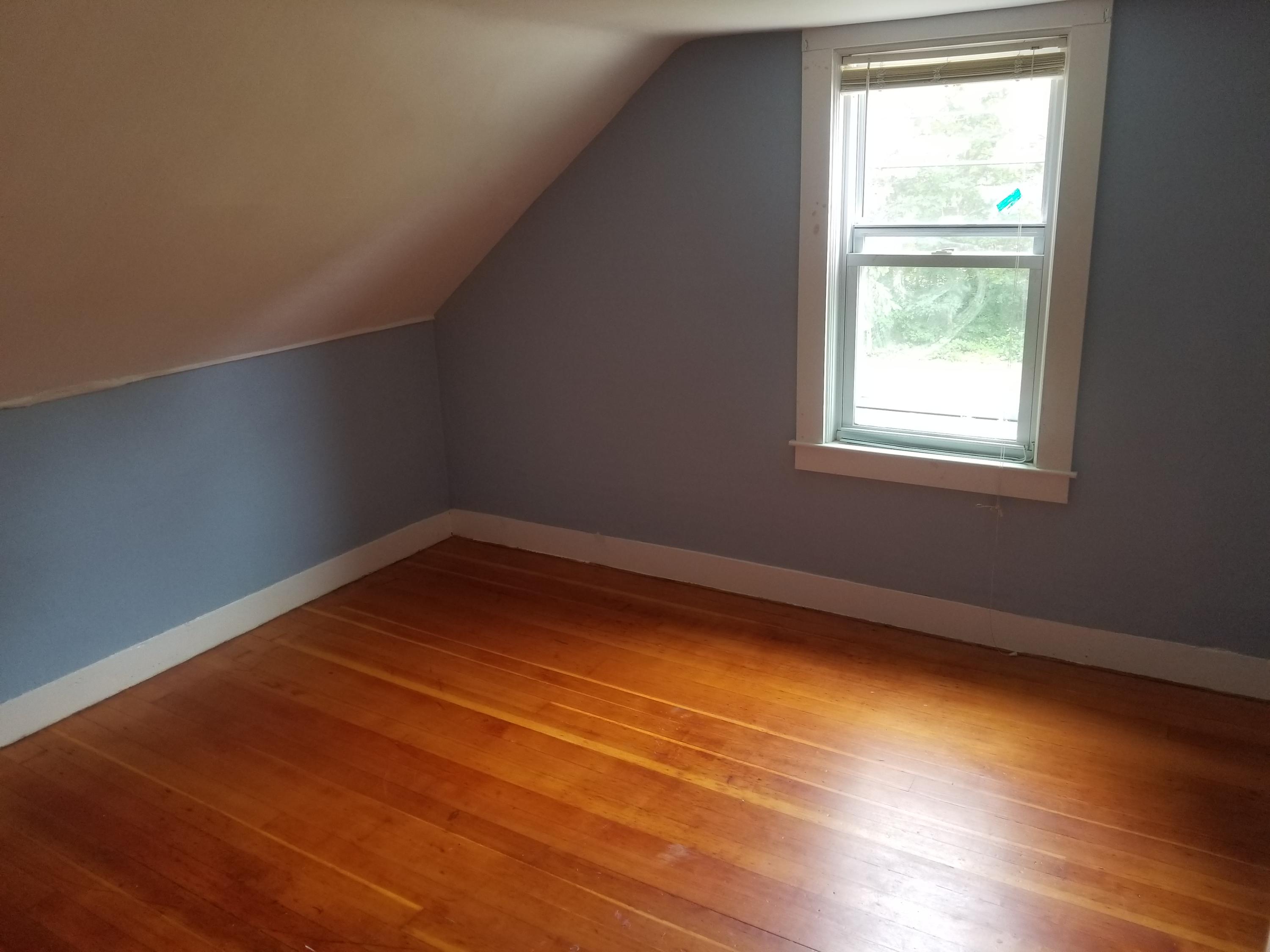 85 Shore Road Bourne, MA 02532 - Photo 9 of 16 an empty room with wooden floor and windows