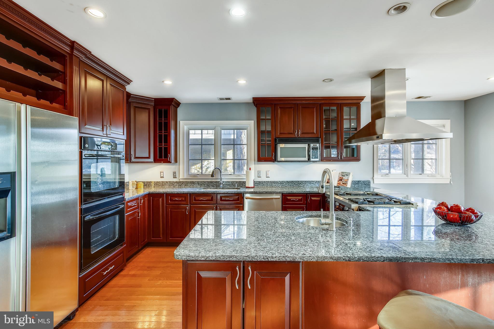 4664 Reservoir Road Northwest Washington, DC 20007 - Photo 13 of 60 a kitchen with stainless steel appliances granite countertop a sink stove and refrigerator