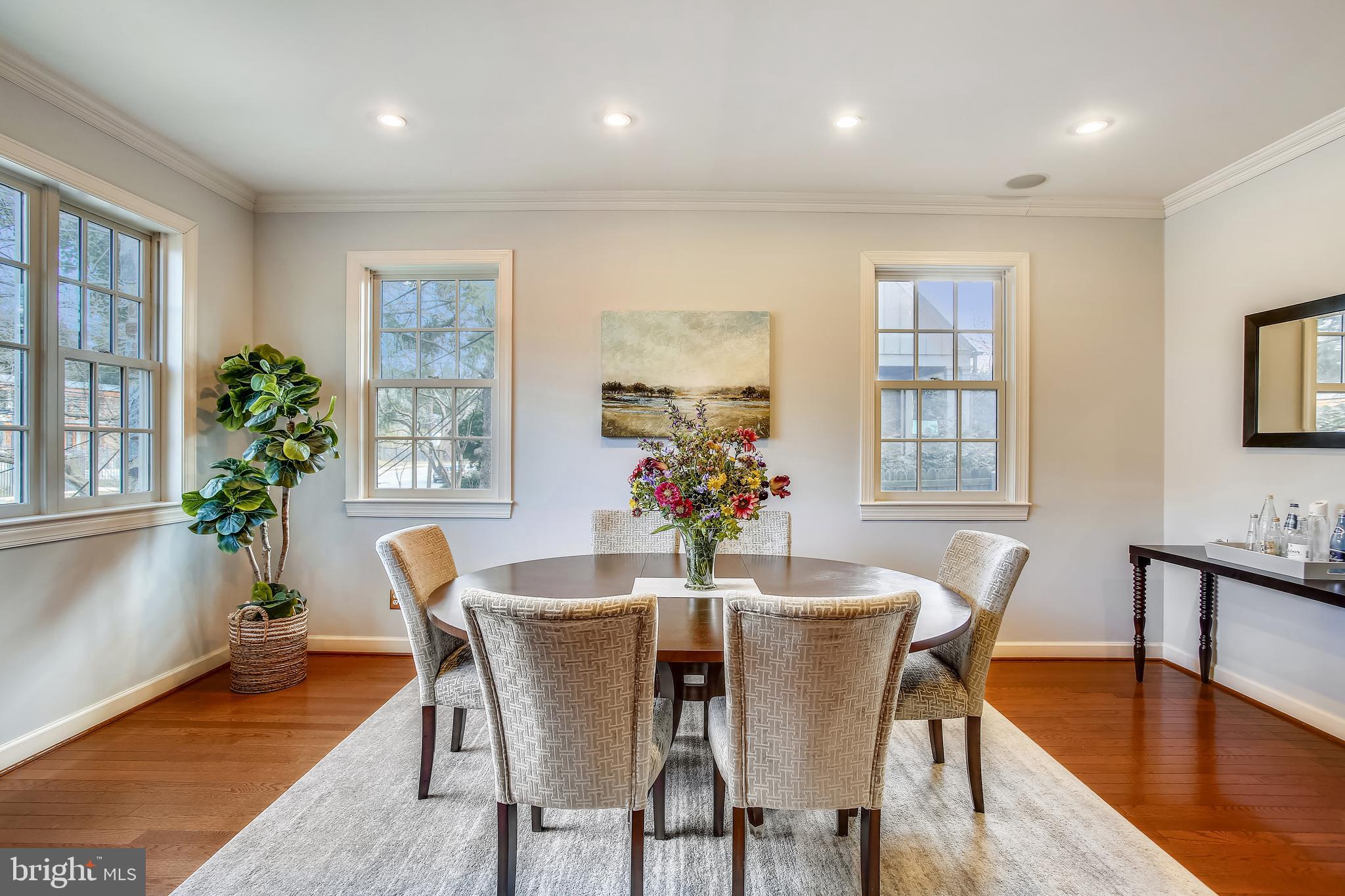 4664 Reservoir Road Northwest Washington, DC 20007 - Photo 25 of 60 a dining room with furniture potted plants and wooden floor