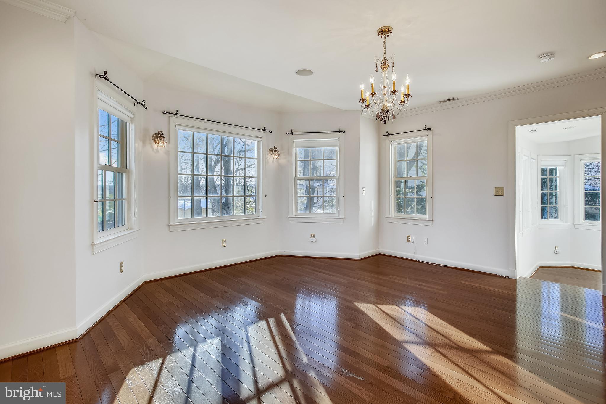 4664 Reservoir Road Northwest Washington, DC 20007 - Photo 30 of 60 a view of an empty room with wooden floor and a window