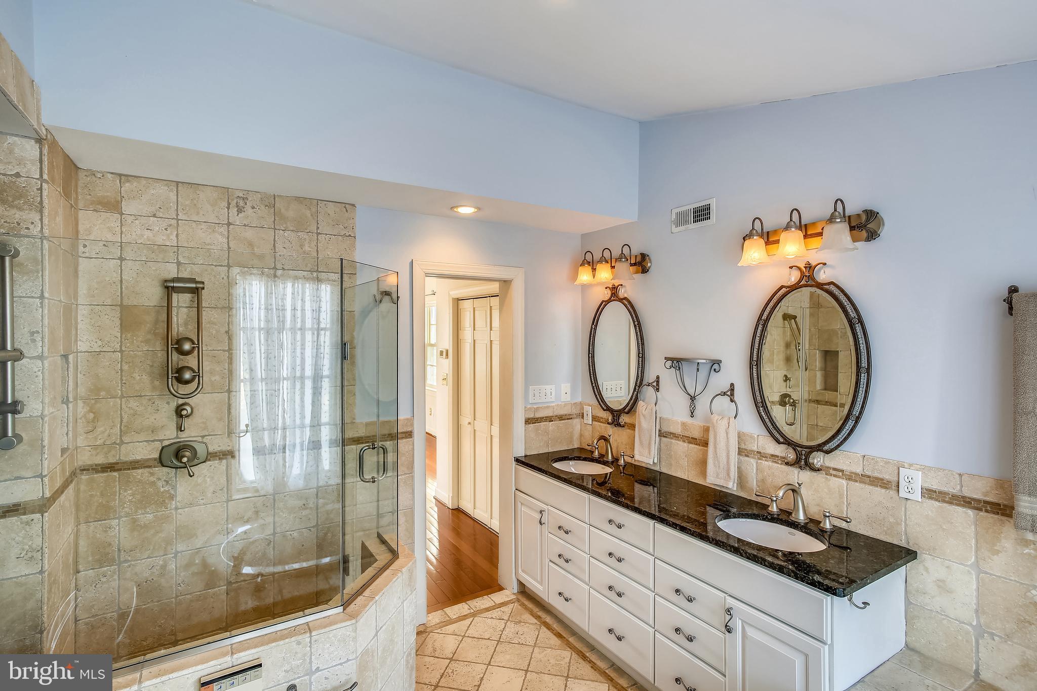 4664 Reservoir Road Northwest Washington, DC 20007 - Photo 34 of 60 a bathroom with a sink a mirror and a shower