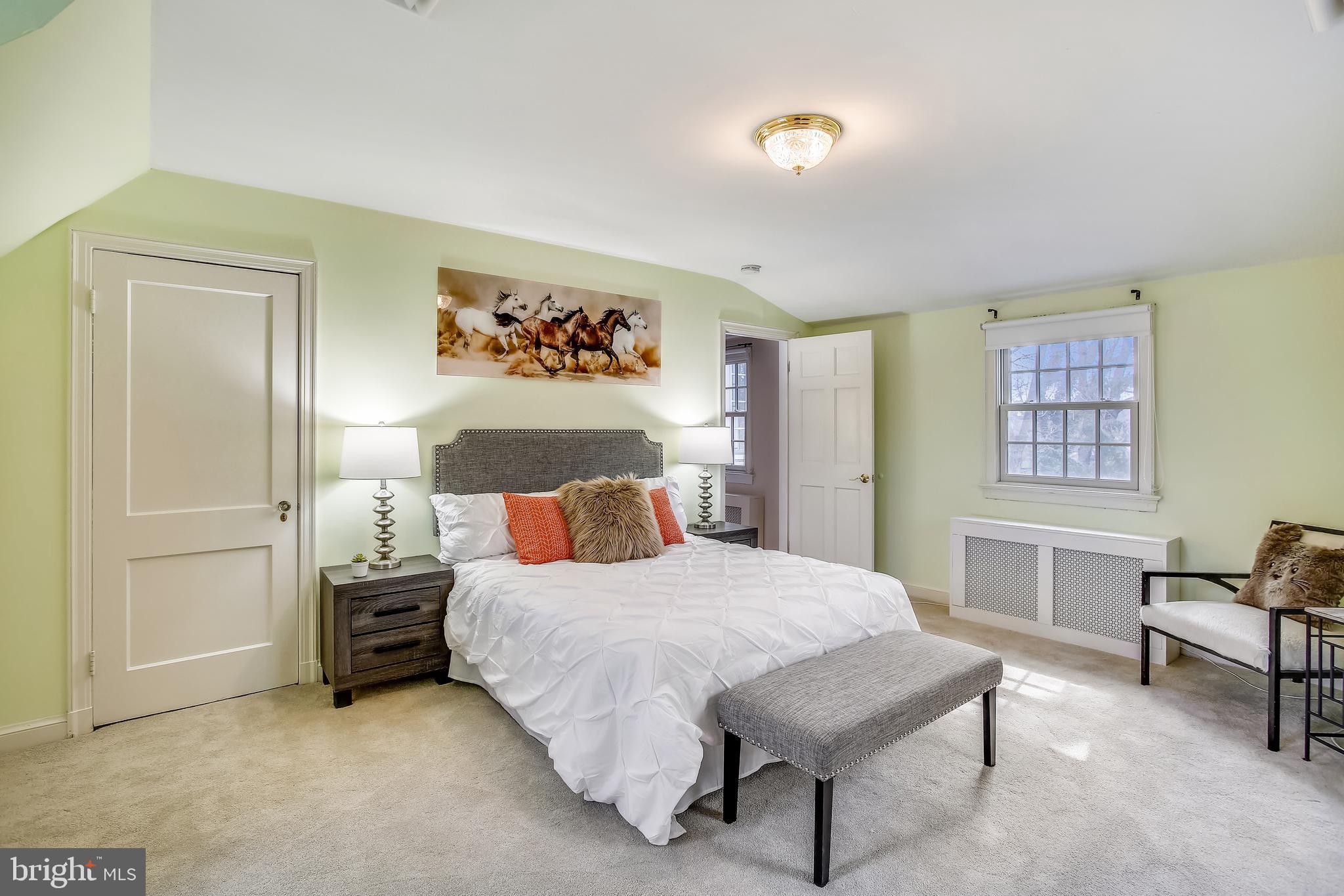 4664 Reservoir Road Northwest Washington, DC 20007 - Photo 37 of 60 a bedroom with a bed a table and painting on the wall