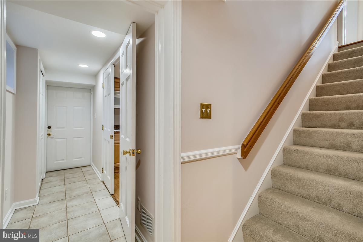 4664 Reservoir Road Northwest Washington, DC 20007 - Photo 43 of 60 a view of hallway with stairs and a white door