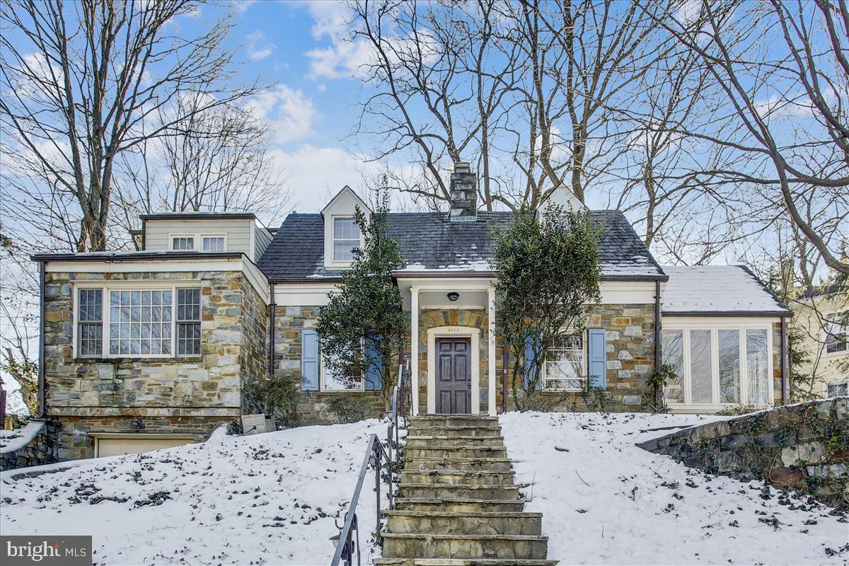 4664 Reservoir Road Northwest Washington, DC 20007 - Photo 53 of 60 a front view of a house with a yard covered in snow