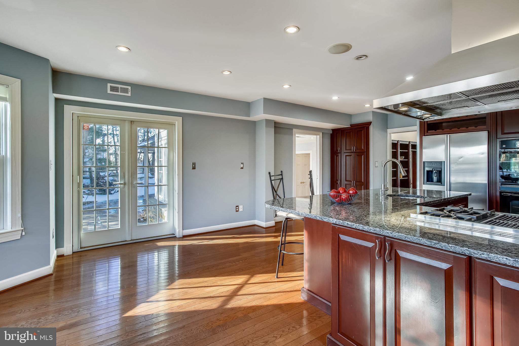 4664 Reservoir Road Northwest Washington, DC 20007 - Photo 8 of 60 a large hall with stainless steel appliances granite countertop a sink and a large mirror next to a window