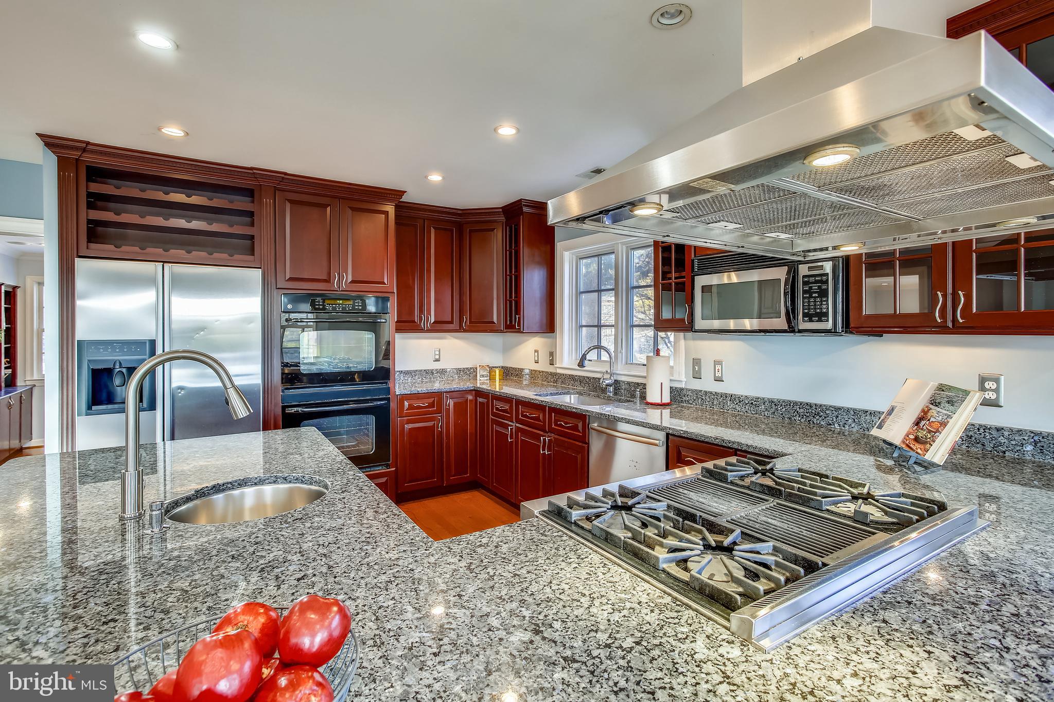 4664 Reservoir Road Northwest Washington, DC 20007 - Photo 9 of 60 a kitchen with stainless steel appliances granite countertop a stove sink and cabinets
