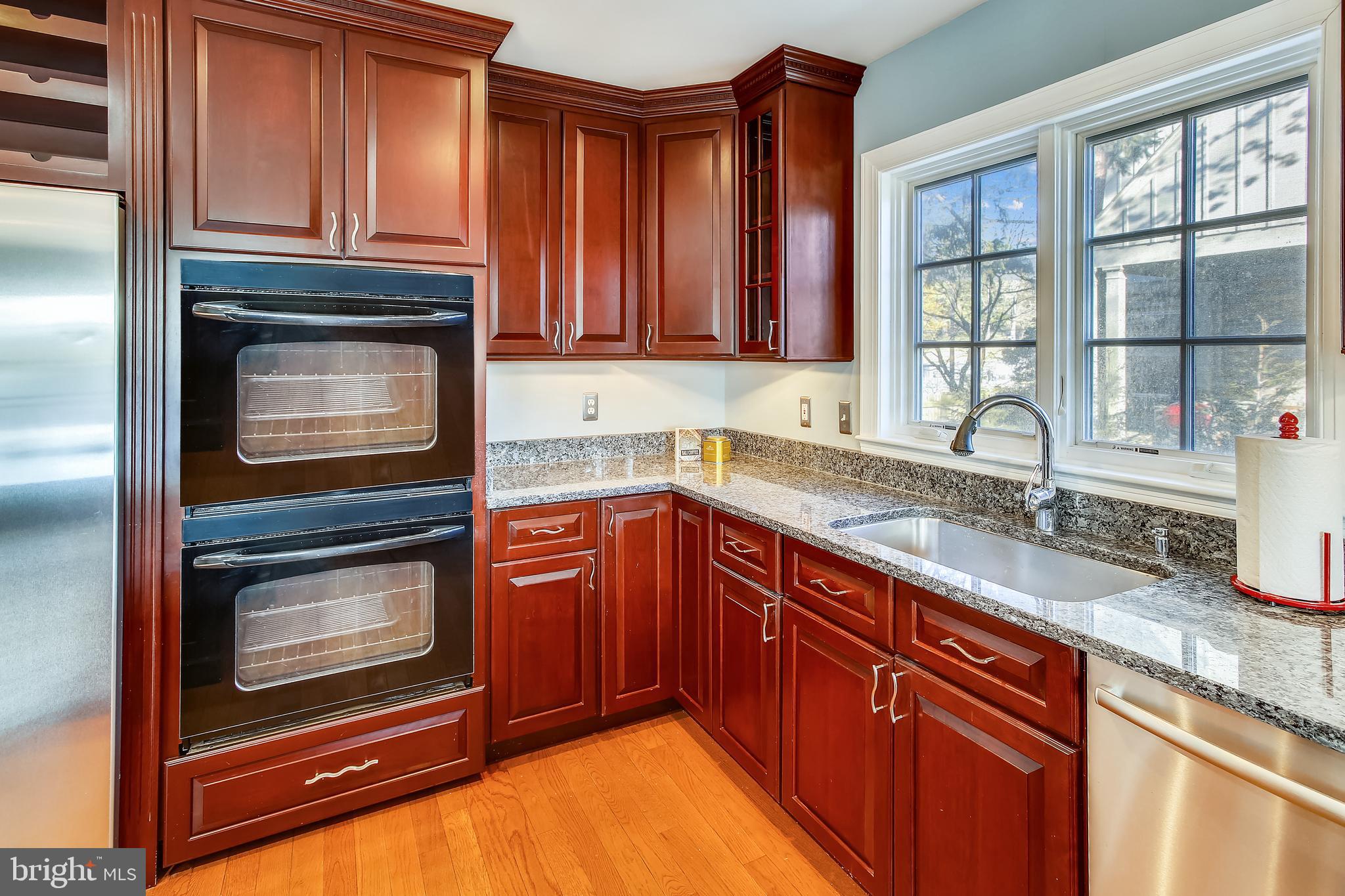 4664 Reservoir Road Northwest Washington, DC 20007 - Photo 10 of 60 a kitchen with granite countertop stainless steel appliances a stove sink and cabinets