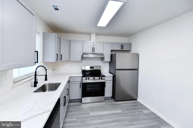 a kitchen with a sink a stove and refrigerator