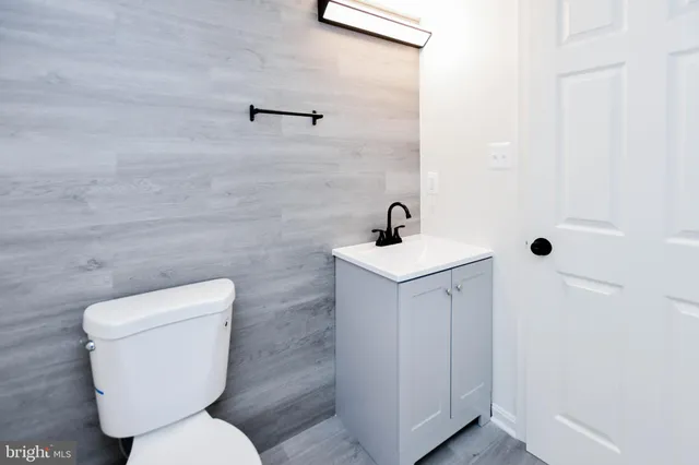 a white toilet sitting next to a bathroom sink