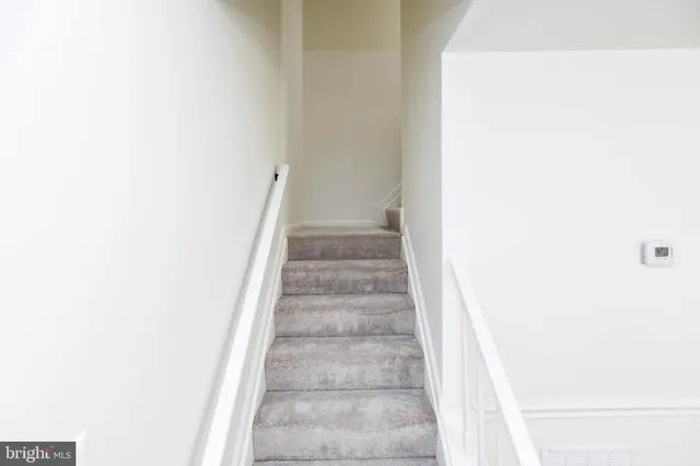 a view of staircase with white walls