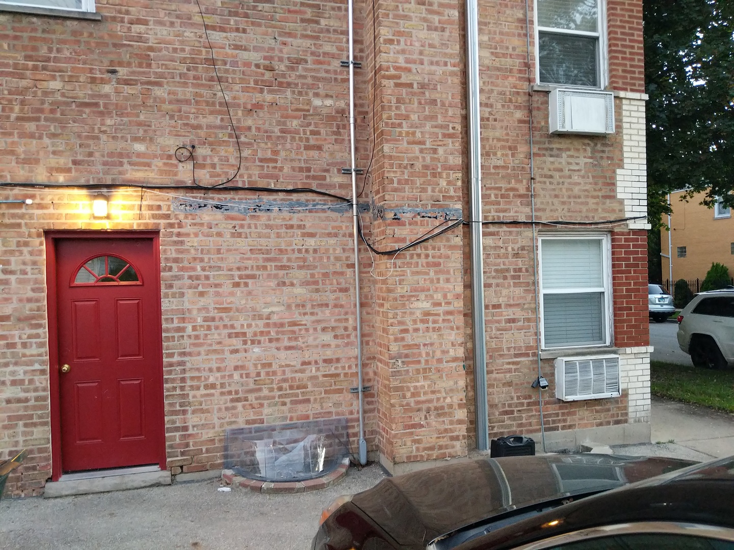 2652 West Rascher Avenue, Unit 203 Chicago, IL 60625 - Photo 16 of 17 a brick building with a bench and a car parked side of it