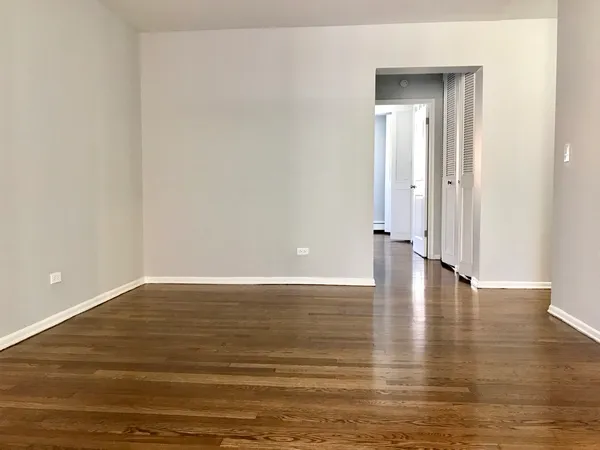 a view of an empty room and wooden floor