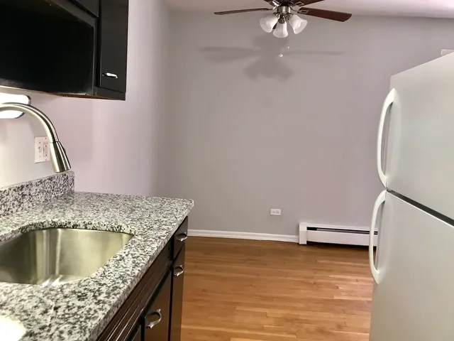 a view of kitchen island with stainless steel appliances granite countertop sink microwave and stove