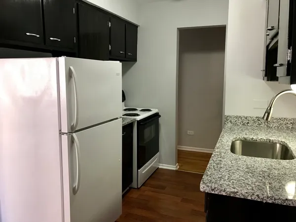 a kitchen with a refrigerator and a sink