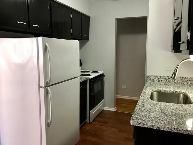 a kitchen with a refrigerator and a sink