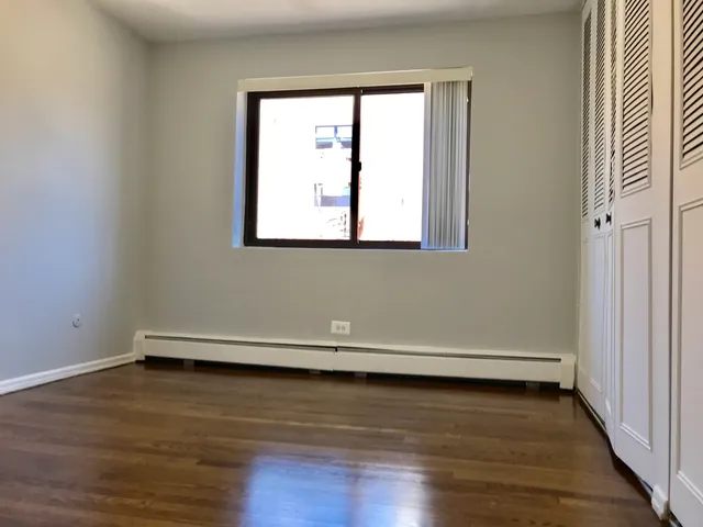 a view of a room with wooden floor and window