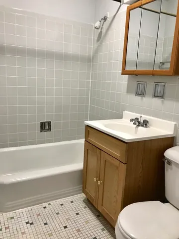 a bathroom with a sink a toilet and bathtub