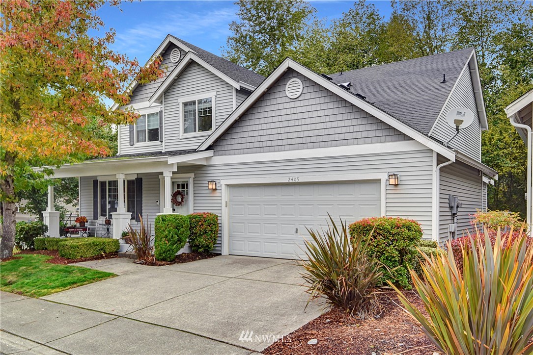 2405 194th Street Southeast Bothell, WA 98012 - Photo 1 of 28 a view of a house with a small yard plants and a large tree