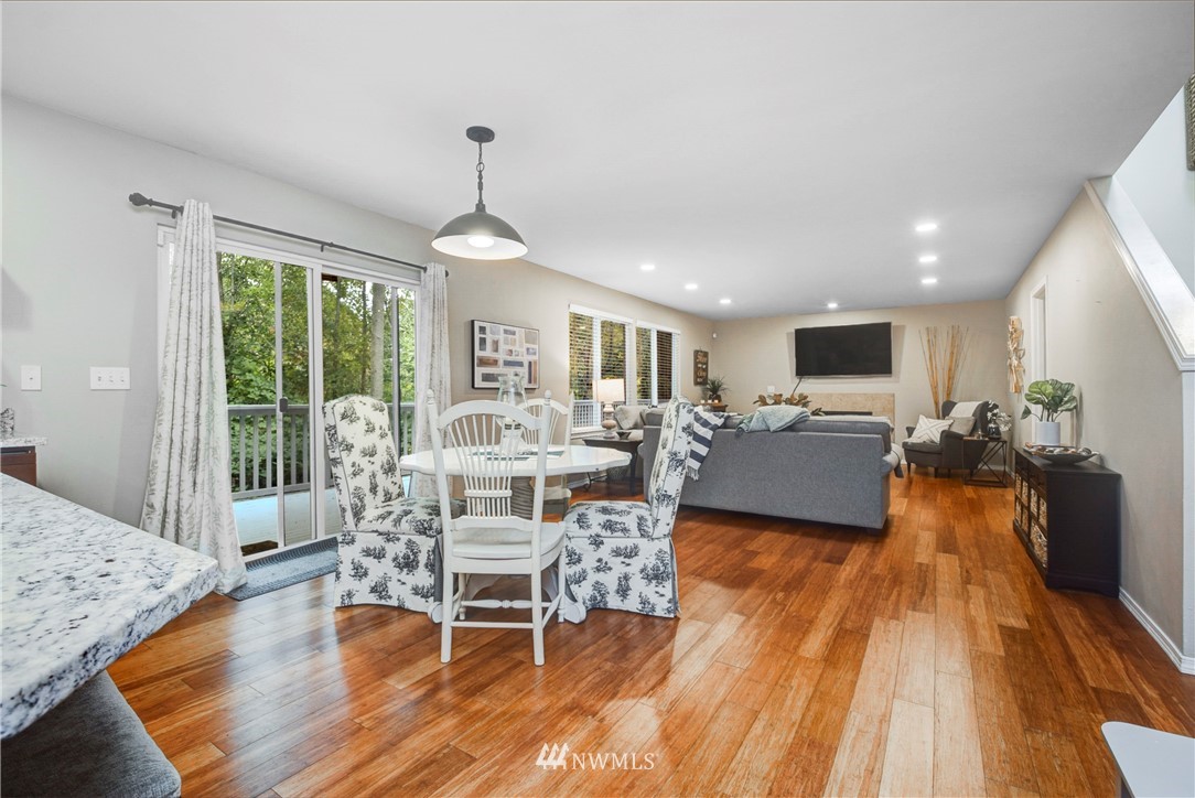 2405 194th Street Southeast Bothell, WA 98012 - Photo 15 of 28 a living room with furniture dining table and a wooden floor