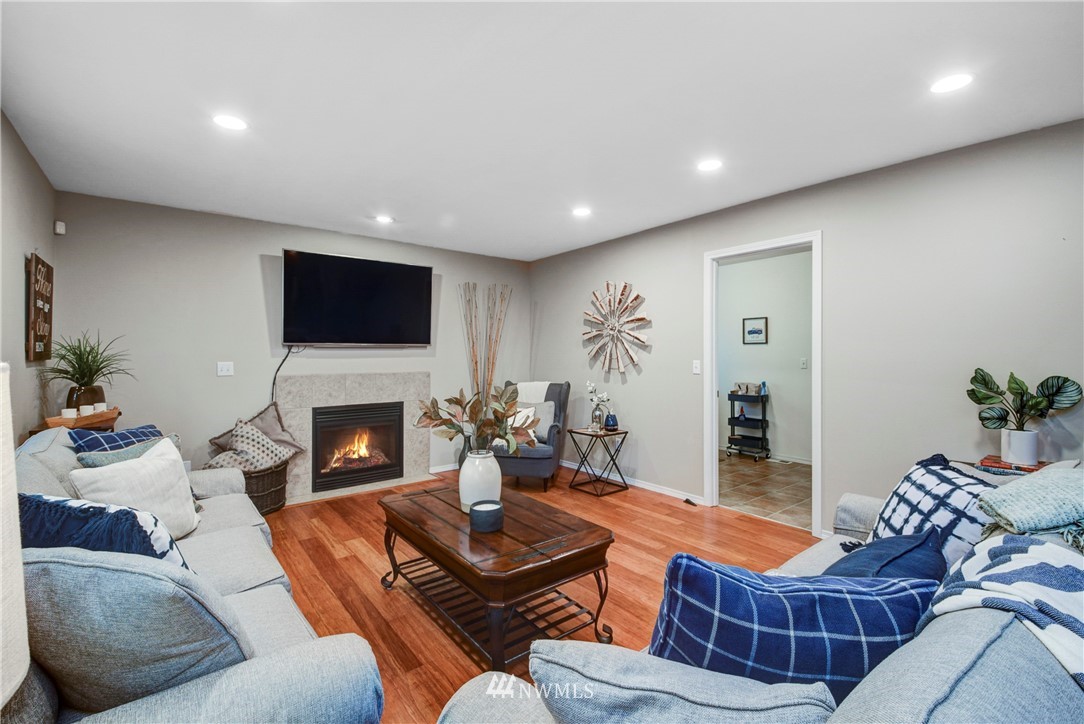 2405 194th Street Southeast Bothell, WA 98012 - Photo 16 of 28 a living room with furniture a fireplace and a flat screen tv