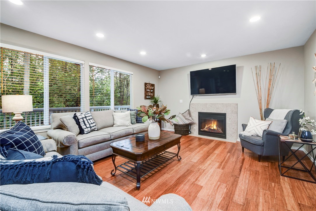 2405 194th Street Southeast Bothell, WA 98012 - Photo 17 of 28 a living room with furniture a fireplace and a flat screen tv