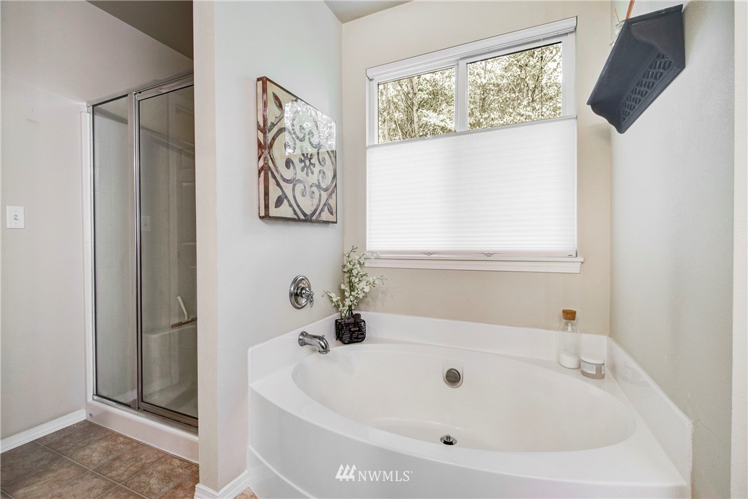 2405 194th Street Southeast Bothell, WA 98012 - Photo 22 of 28 a white bath tub sitting next to a window