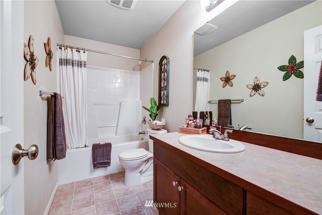 2405 194th Street Southeast Bothell, WA 98012 - Photo 26 of 28 a bathroom with a sink a toilet and shower curtain