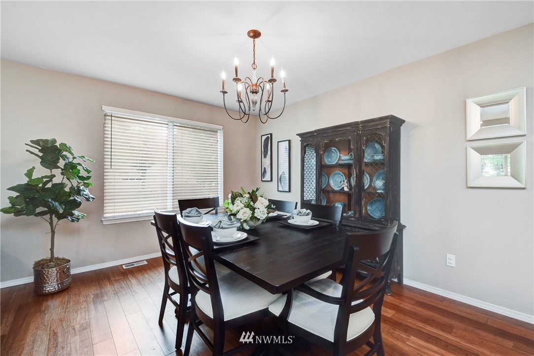 2405 194th Street Southeast Bothell, WA 98012 - Photo 8 of 28 a view of a dining room with furniture window and wooden floor