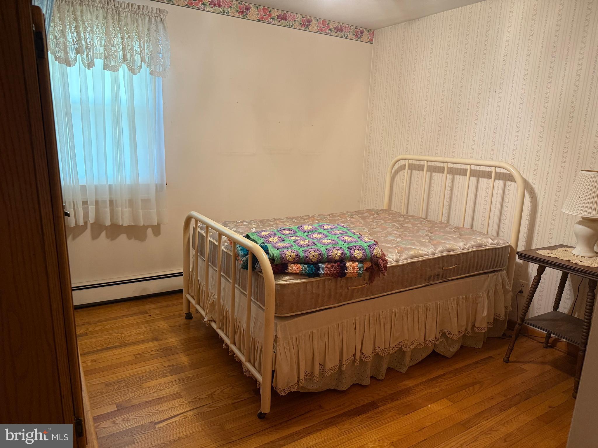 405 Parvin Mill Road Bridgeton, NJ 08302 - Photo 12 of 28 a bedroom with a bed and a window
