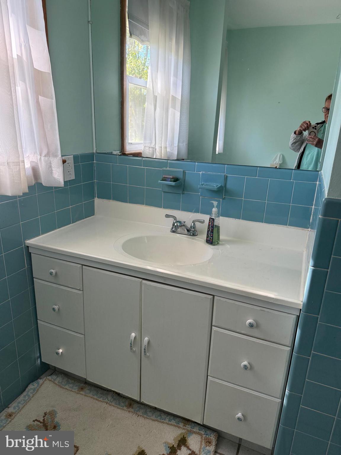 405 Parvin Mill Road Bridgeton, NJ 08302 - Photo 16 of 28 a bathroom with a sink and a mirror