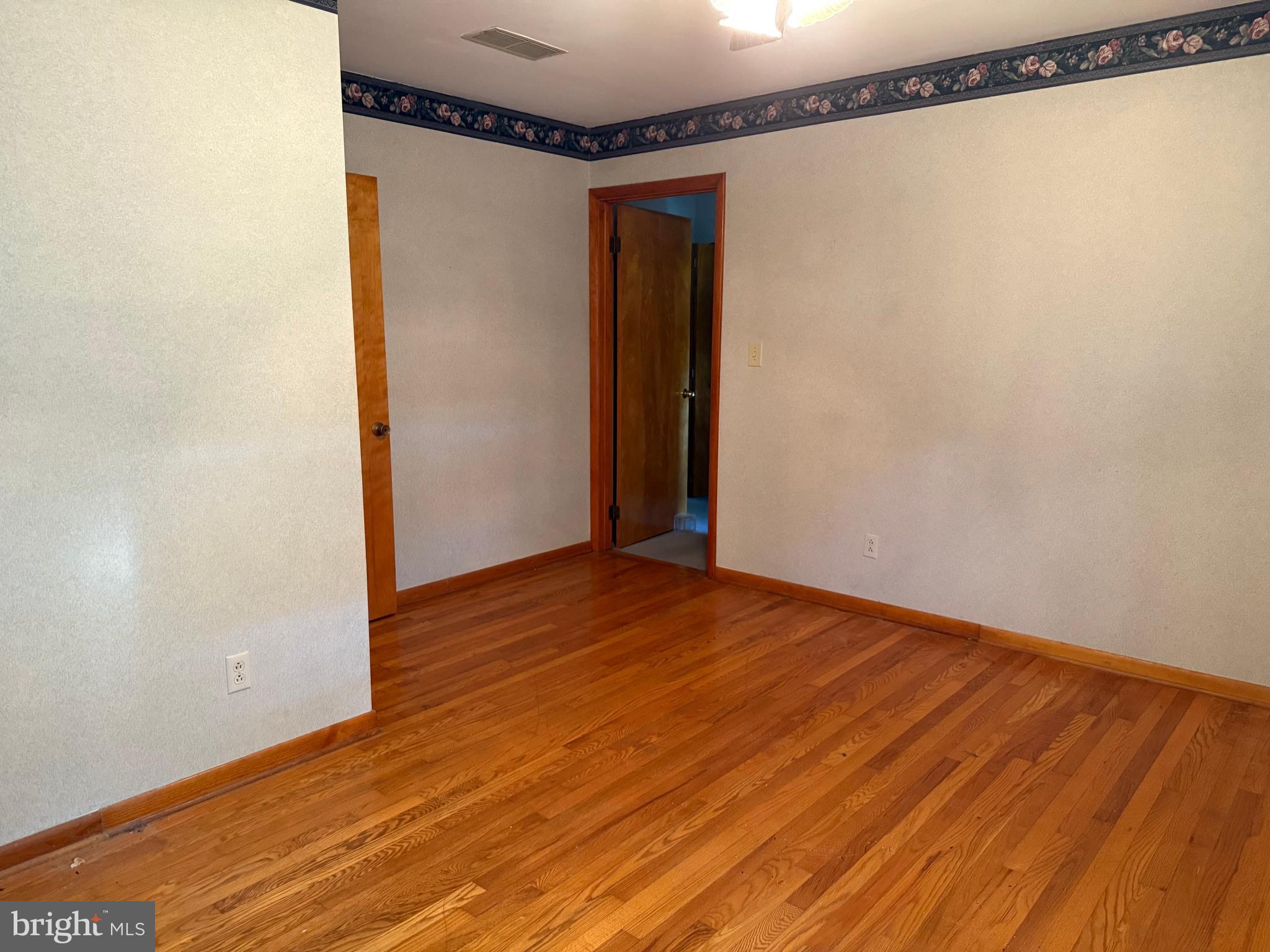 405 Parvin Mill Road Bridgeton, NJ 08302 - Photo 18 of 28 a view of a room with wooden floor and a shower
