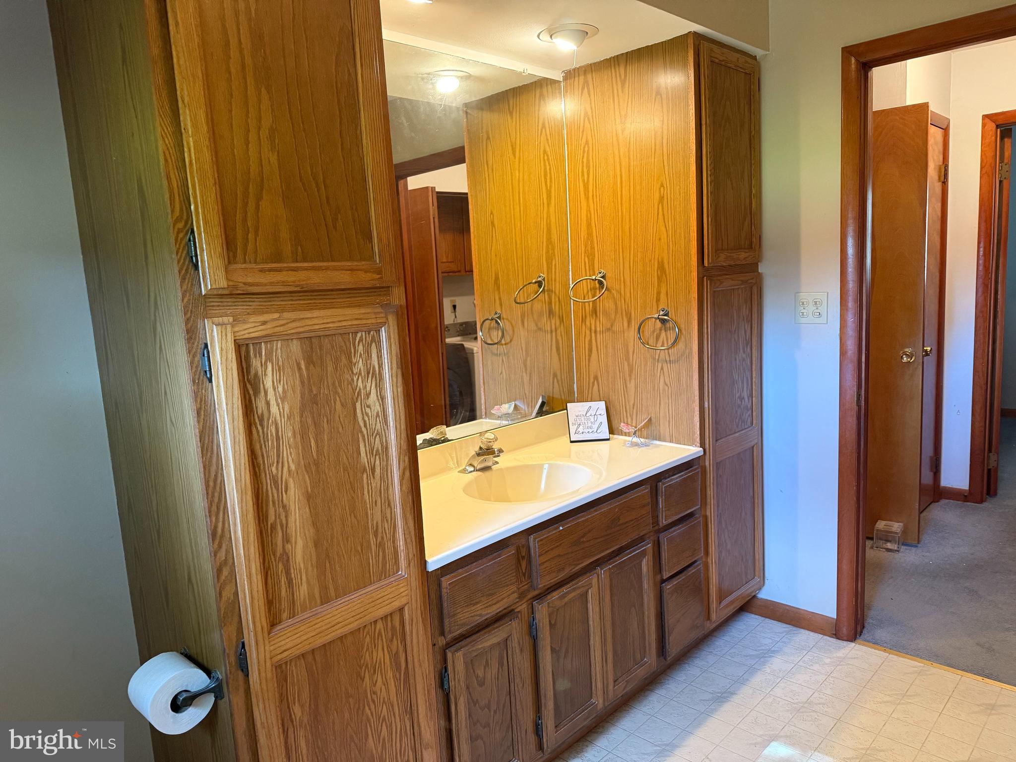 405 Parvin Mill Road Bridgeton, NJ 08302 - Photo 20 of 28 a bathroom with a double vanity sink and mirror